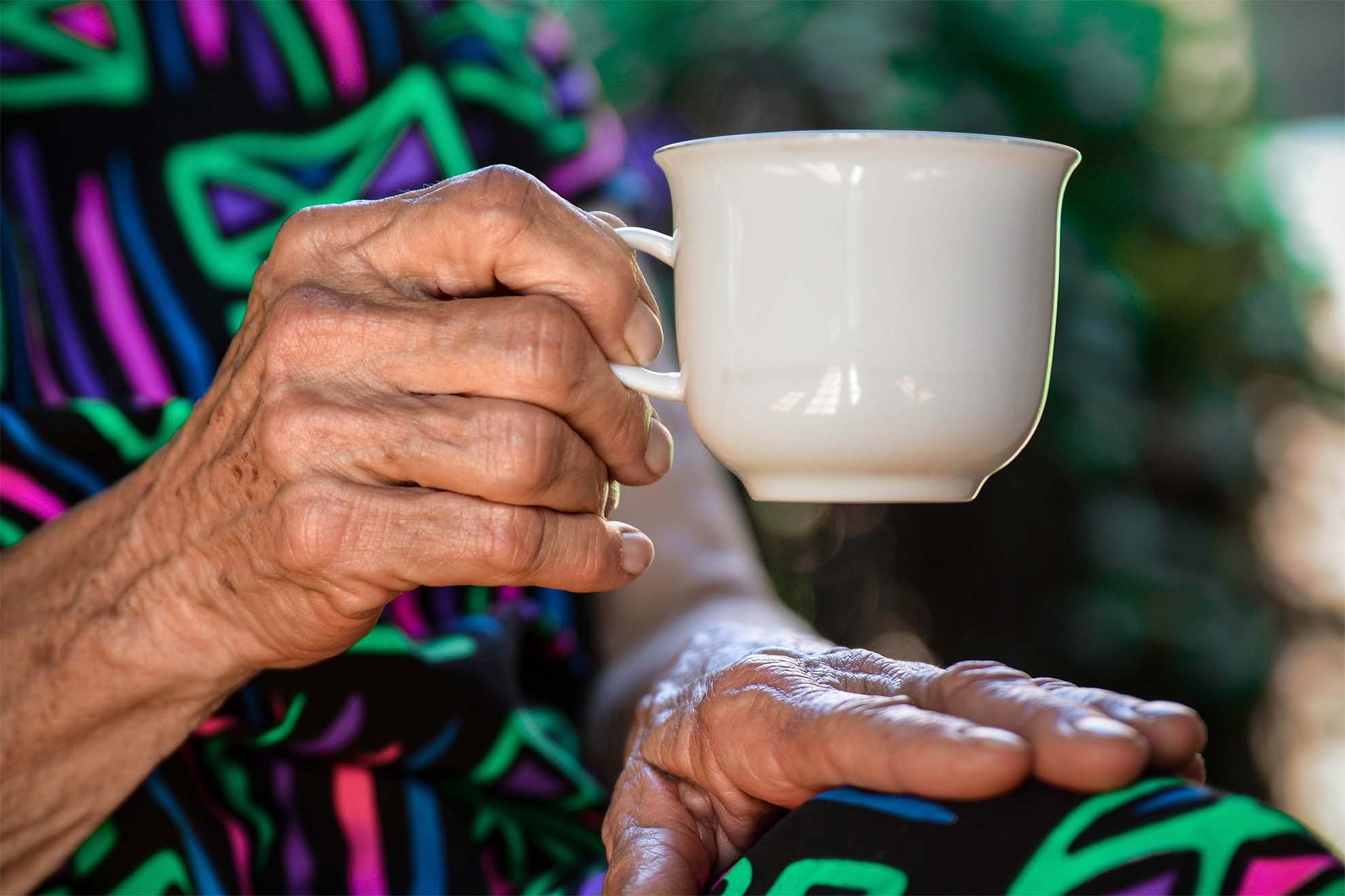 resident with a hot drink in their hand