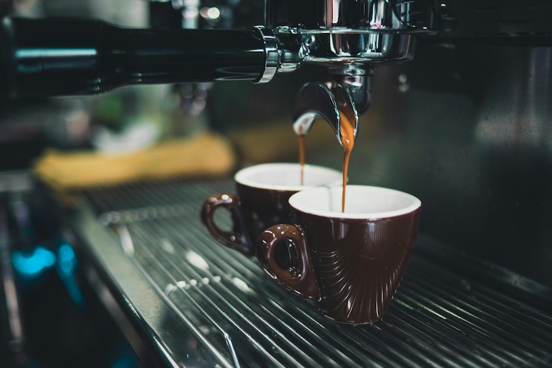 a coffee machine pouring into a mug