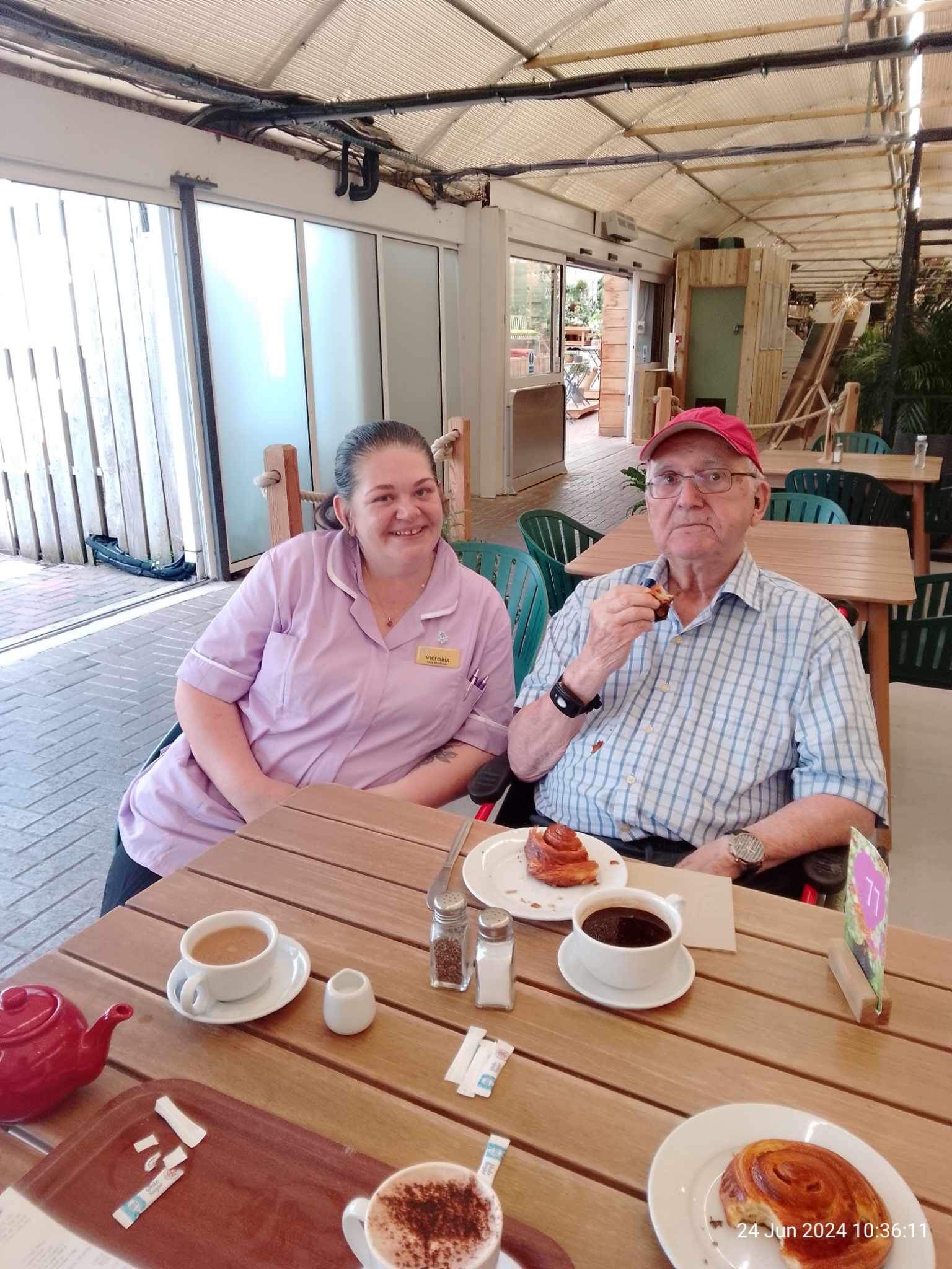 resident with cake and tea