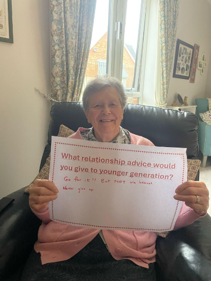 resident with a sign talking about her love advice