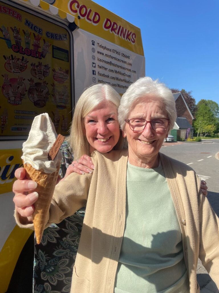 resident smiling holding an ice cream