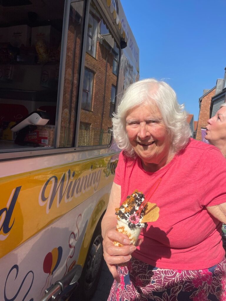 resident smiling holding an ice cream