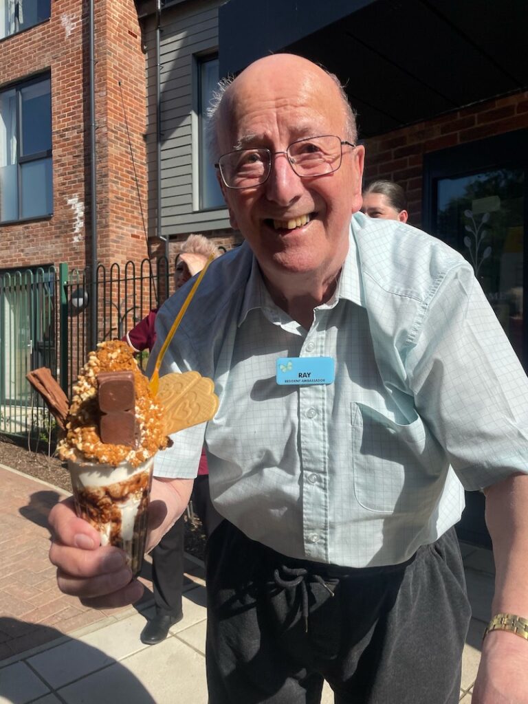 resident smiling holding an ice cream