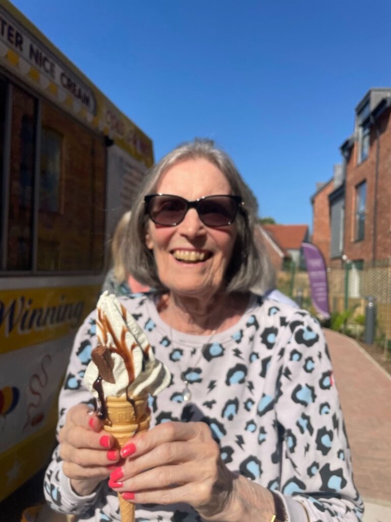 resident smiling holding an ice cream