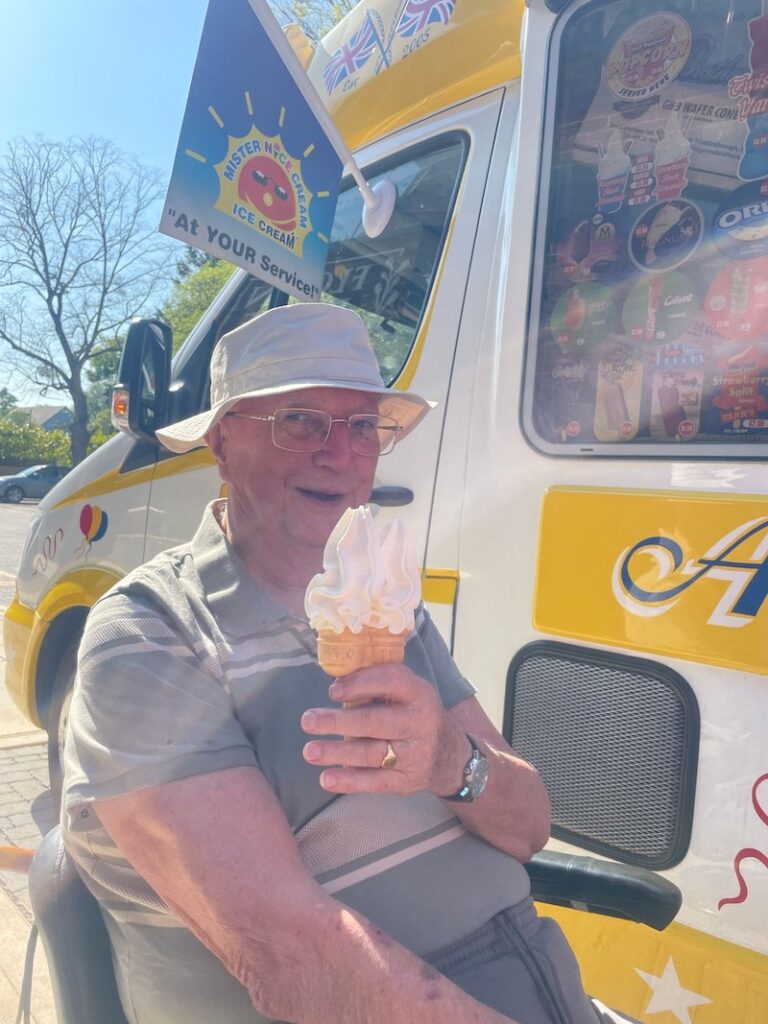 resident smiling holding an ice cream