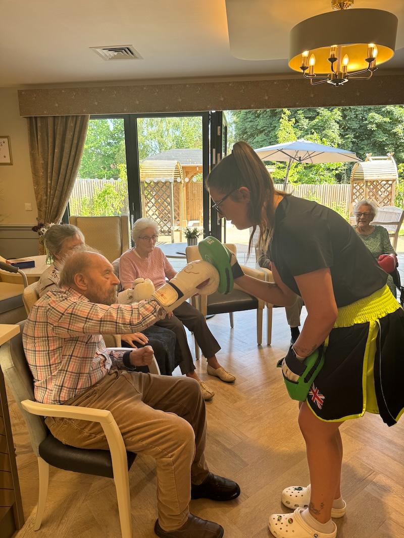 residents enjoying boxing class with team members
