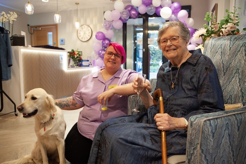 resident and carer together with a dog