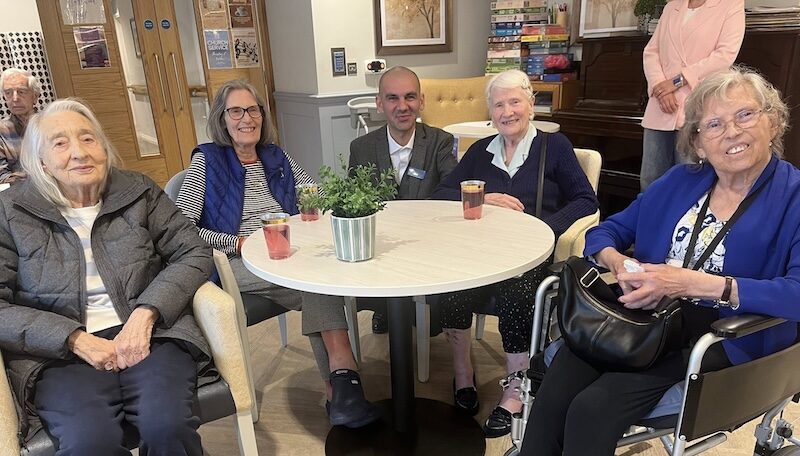a group photo of our residents sat down in the cafe