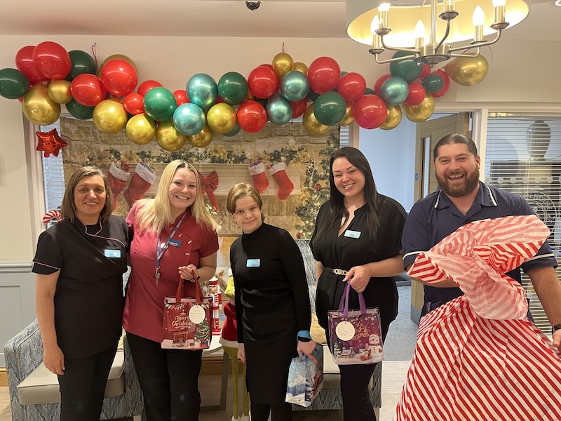 a variety of team members at Floryn House posing in front of christmas decorations