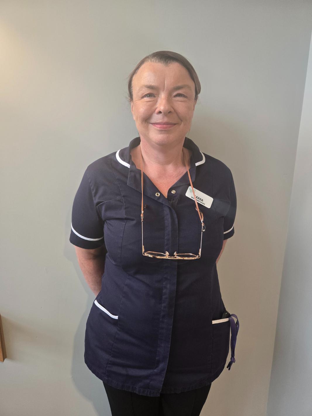 lady smiling at camera for staff photo