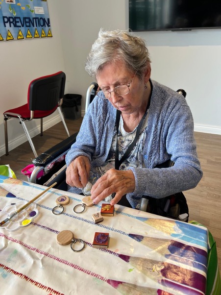 older lady doing arts and crafts