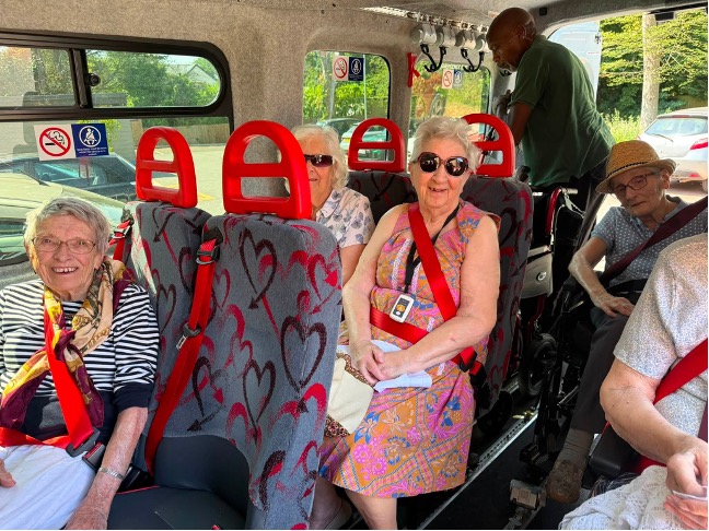 older adults sat in a minibus