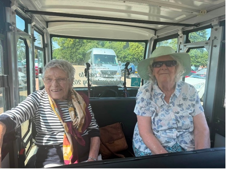 two older ladies sat at the back of a minibus