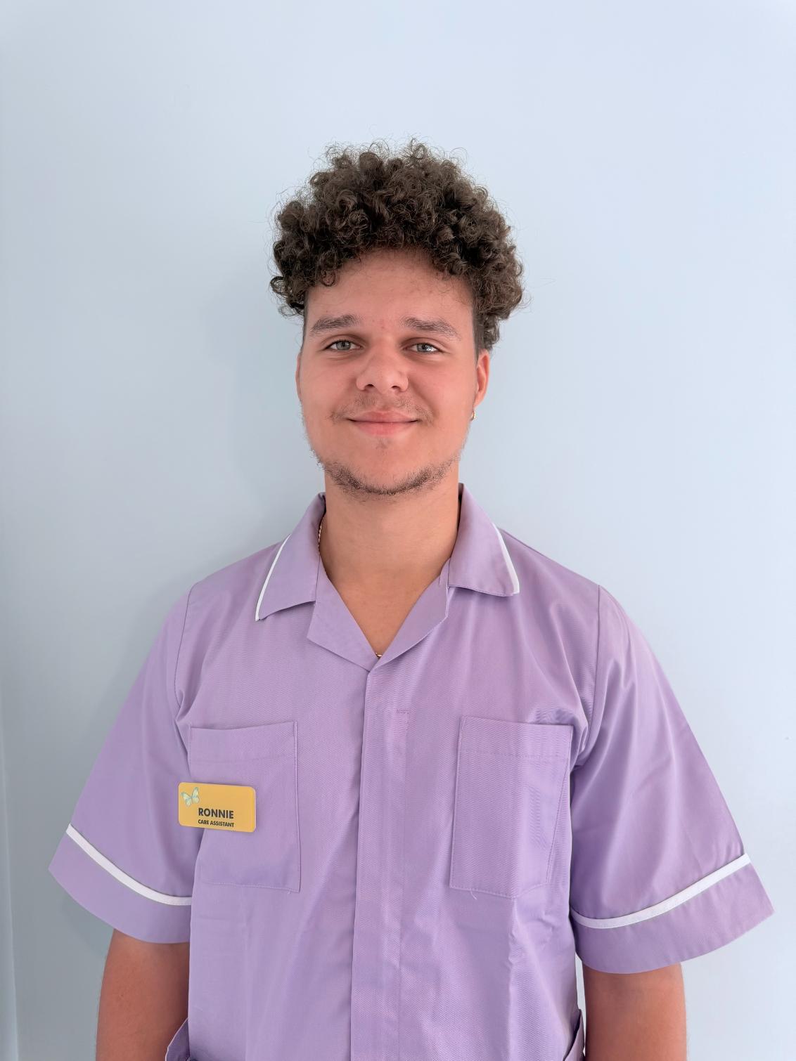 man standing for staff photo